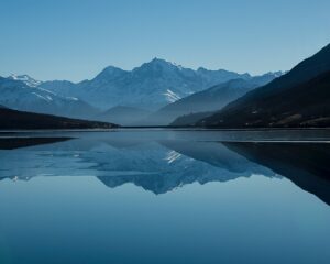 calm body of lake between mountains