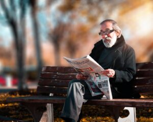 photo of man reading newspaper
