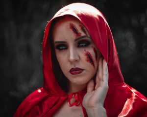 woman wearing red hood with makeup