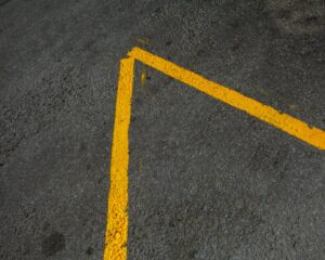 yellow markings on asphalt road in city