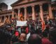 people protesting outside a building