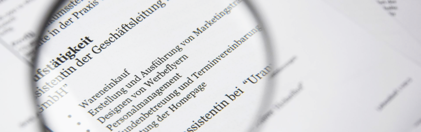magnifying glass beside white printer paper