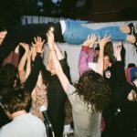 people lifting man at night