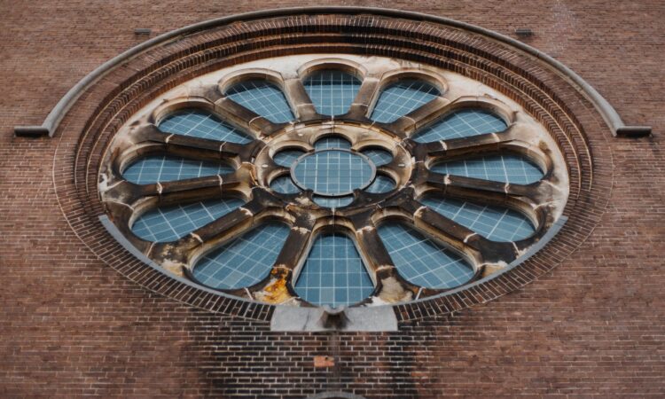 brick wall with round framed glass window