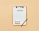 pencil and letter tiles on a clipboard